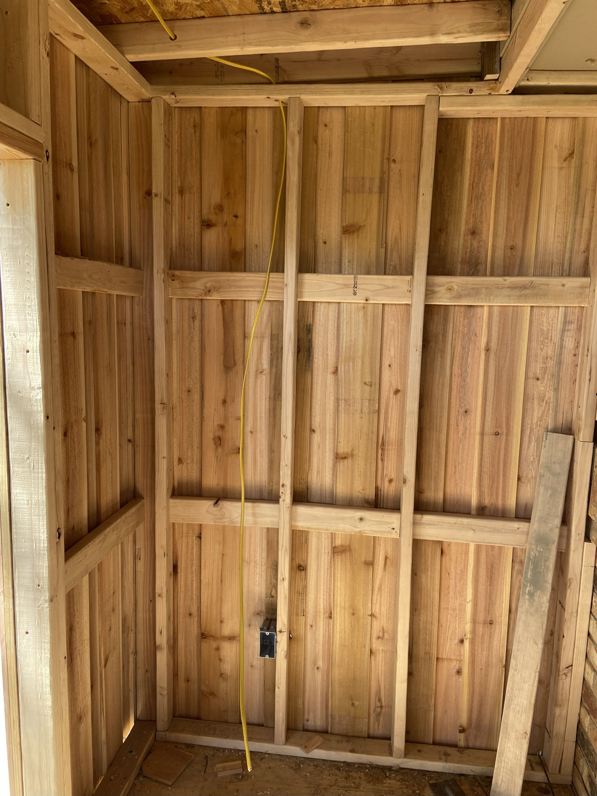 Wooden wall framing with electrical wiring in place. Interior construction.