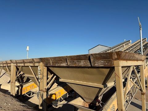 Industrial equipment with multiple bins against a clear blue sky.