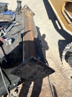 Metal fabricated structure with triangular mounting plates and a rectangular spine.