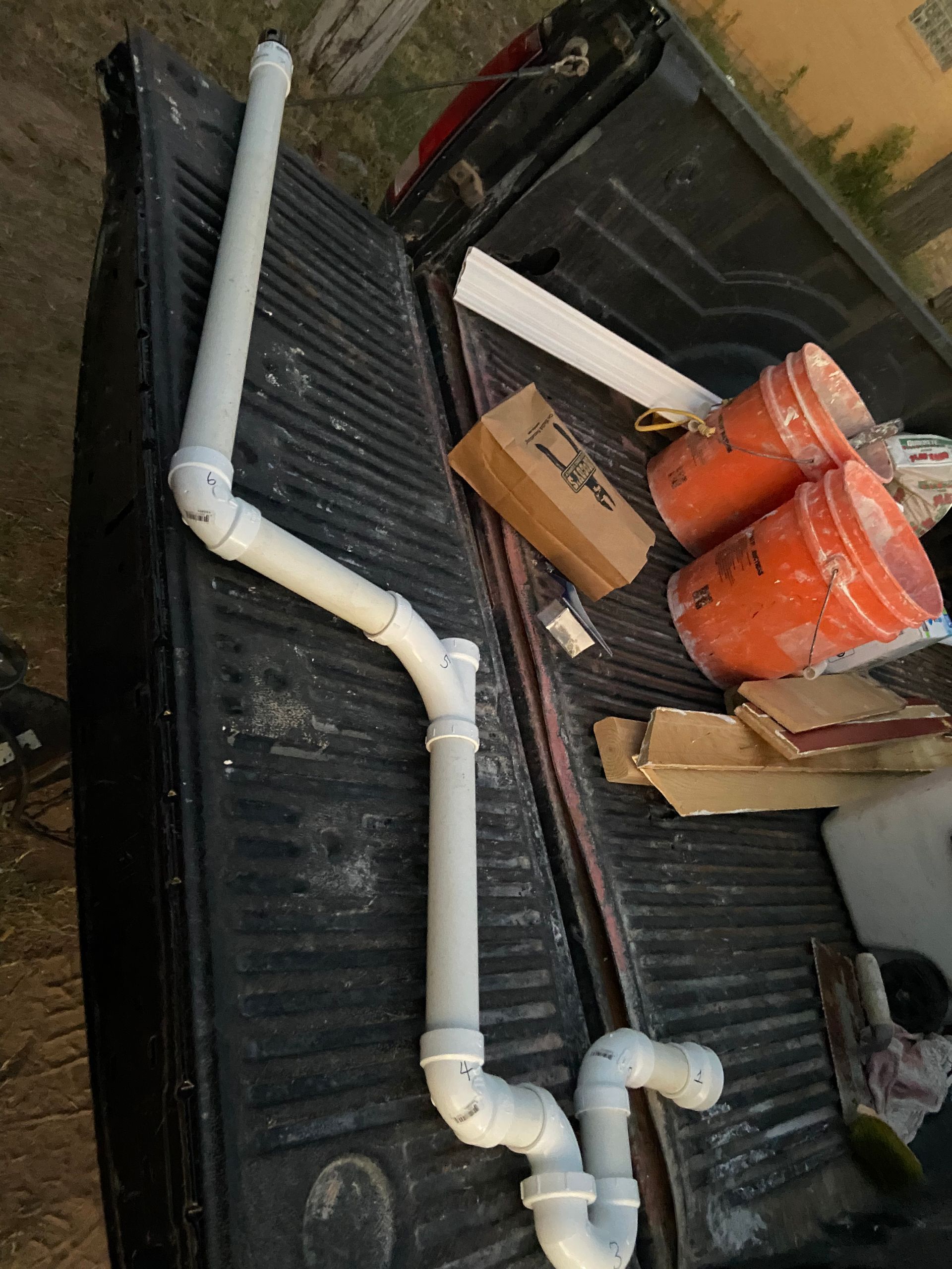 PVC pipes and fittings assembled in a truck bed.