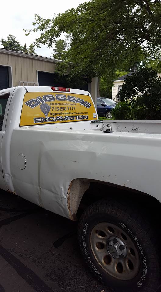 White truck with Diggers Excavation on the back window