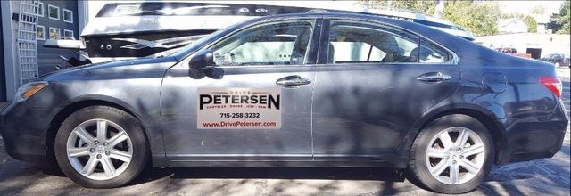 Silver car with removable door sign