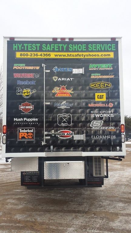 Rear of truck with various logos on it