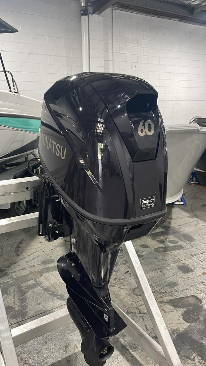 Black Tohatsu 60 Outboard Motor Displayed on a Boat in a Showroom — In Tune Marine in West End, QLD