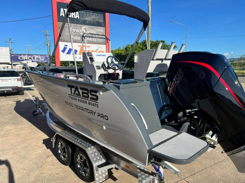 Silver Tabs Boat on a Trailer, Black Motor — In Tune Marine in Airlie Beach, QLD