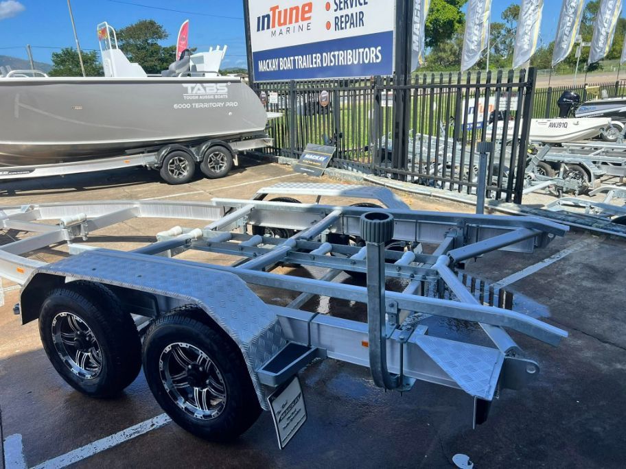 Boat Trailer With Two Axles, Silver Frame, and Black Tires — In Tune Marine in West End, QLD