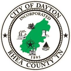 City of Dayton, TN seal: green map, buildings, tractor, and star on white background, black text.