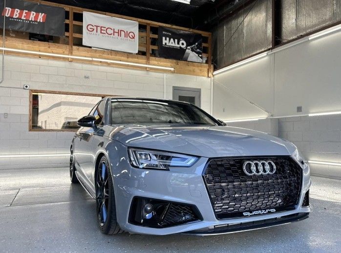 Gray Audi sports car in an indoor showroom, front view with Audi grille visible