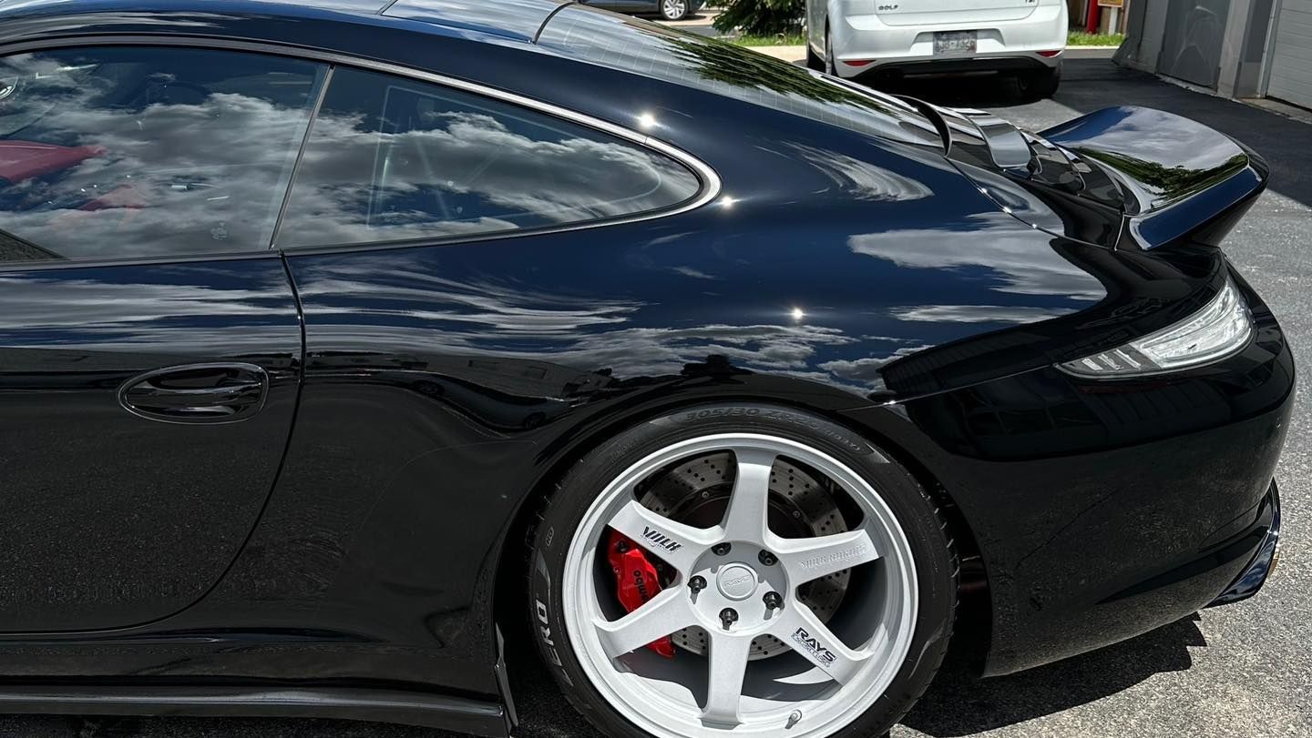 a black vehicle with window tinting parked outside