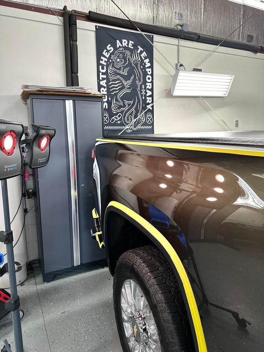 Car being detailed in a garage with a 