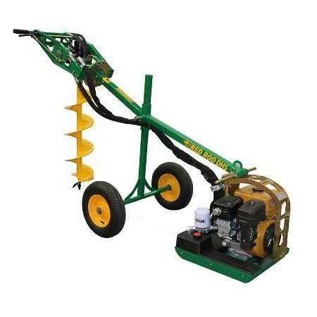 Green and yellow post hole digger with auger, engine, and wheels.
