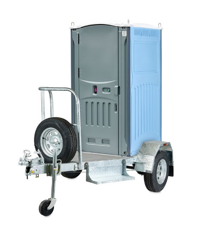 Portable toilet on trailer, gray and blue plastic, with spare tire.
