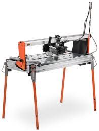Orange and silver tile saw on a stand, cutting tile.