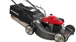 Honda lawnmower with black grass bag, red engine, and gray deck, ready for mowing.