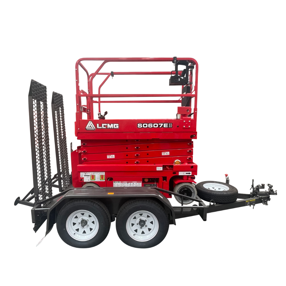 Red LCMC 3030T scissor lift on a trailer with black ramps, white wheels.