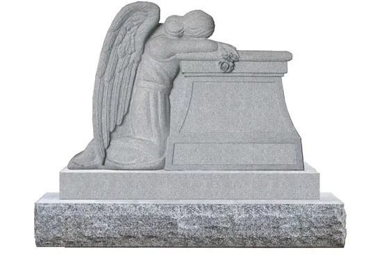 Gray stone angel statue leaning over a tomb, shown in profile on a base