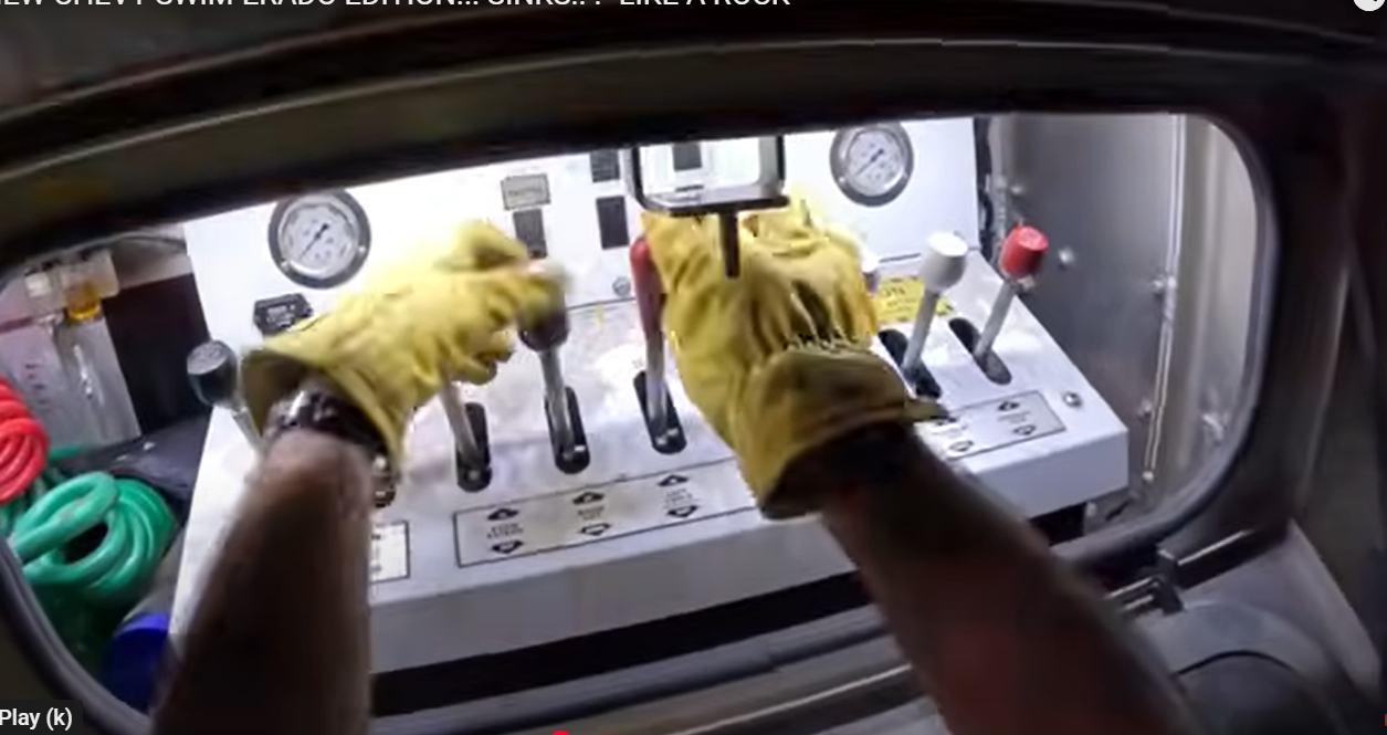 Operator using console to operate tow truck winch during emergency towing situation