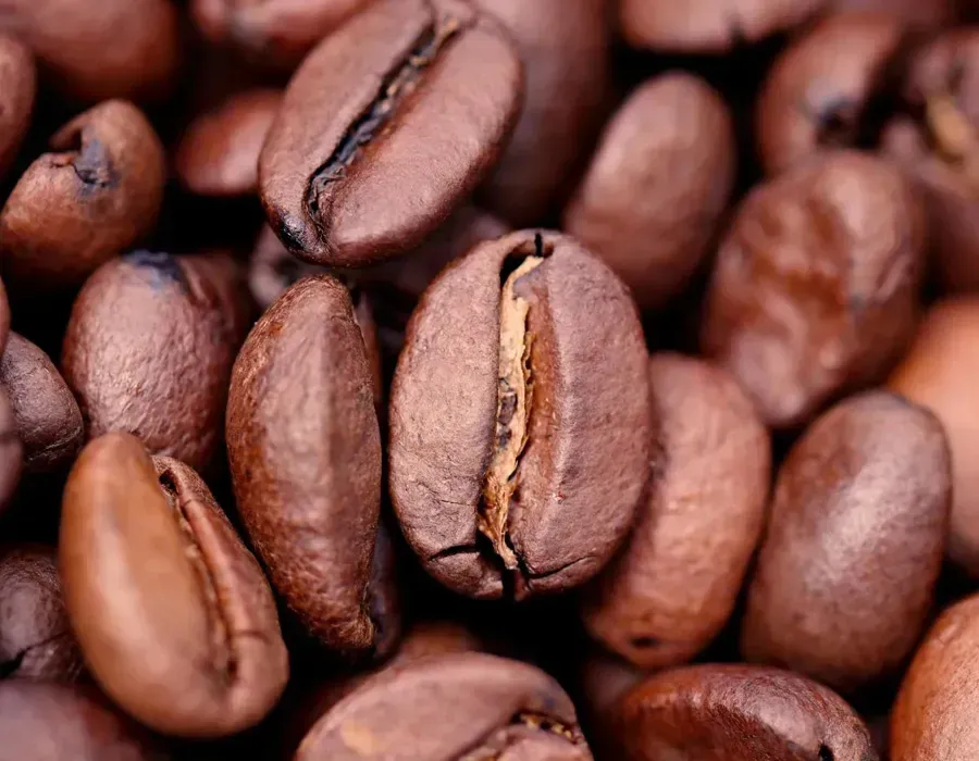 Close-up of roasted coffee beans, various shades of brown.