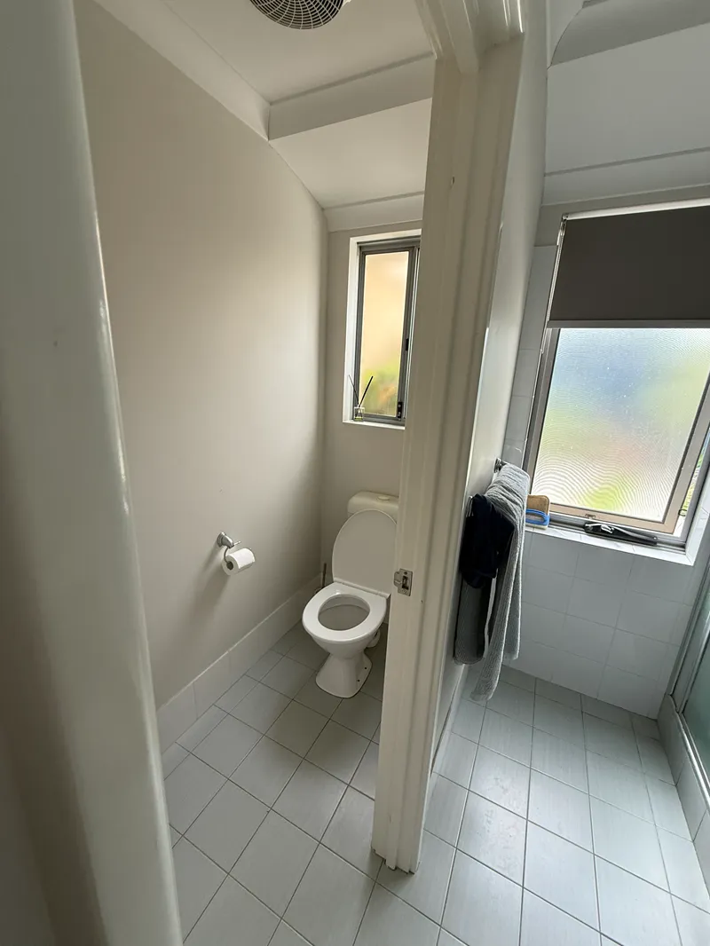 Old bathroom before complete renovation of the shower area