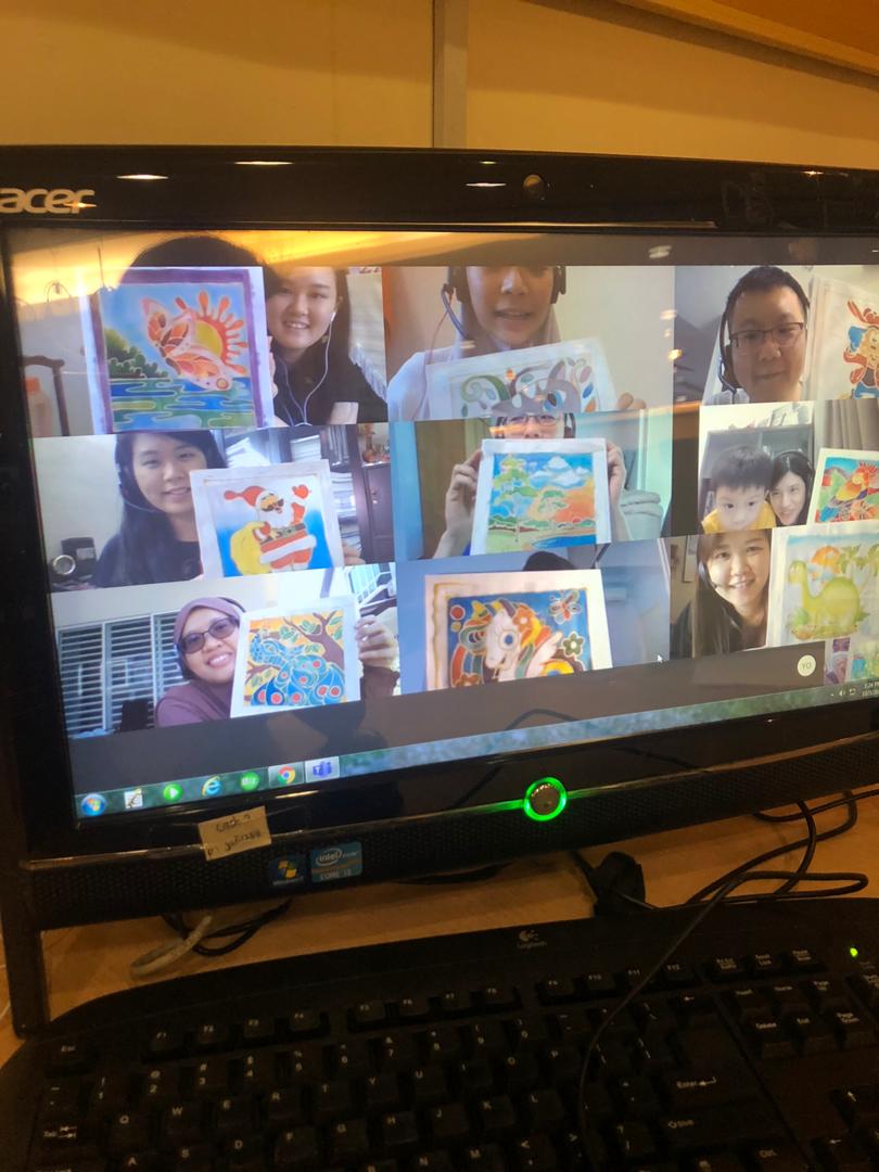 Online art class: Students on video call hold up colorful paintings for display.