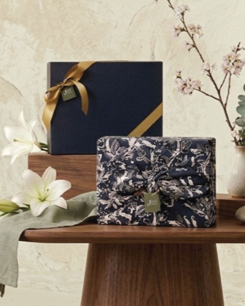 Basket of skincare products with tropical flowers.