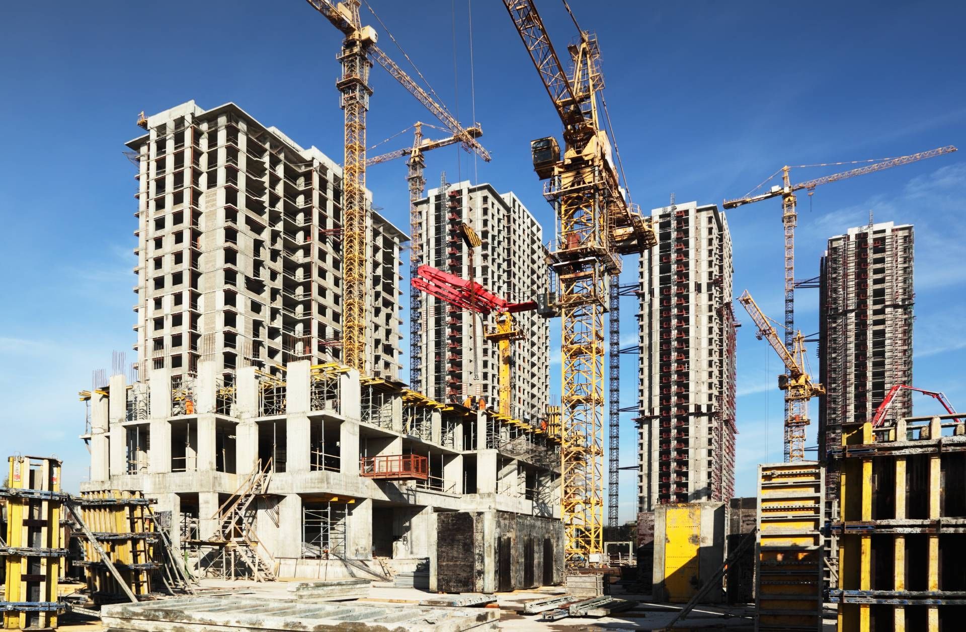 A construction site with a lot of cranes and buildings under construction.