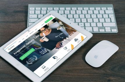 Tablet showing a fitness app on a desk with keyboard and mouse nearby