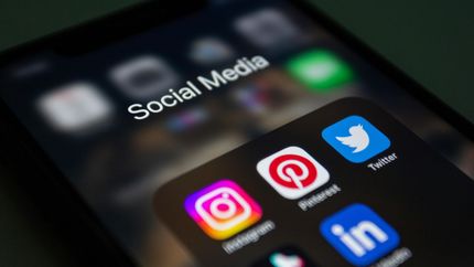 Smartphone screen showing social media app icons, including Instagram, Pinterest, Twitter, and LinkedIn.