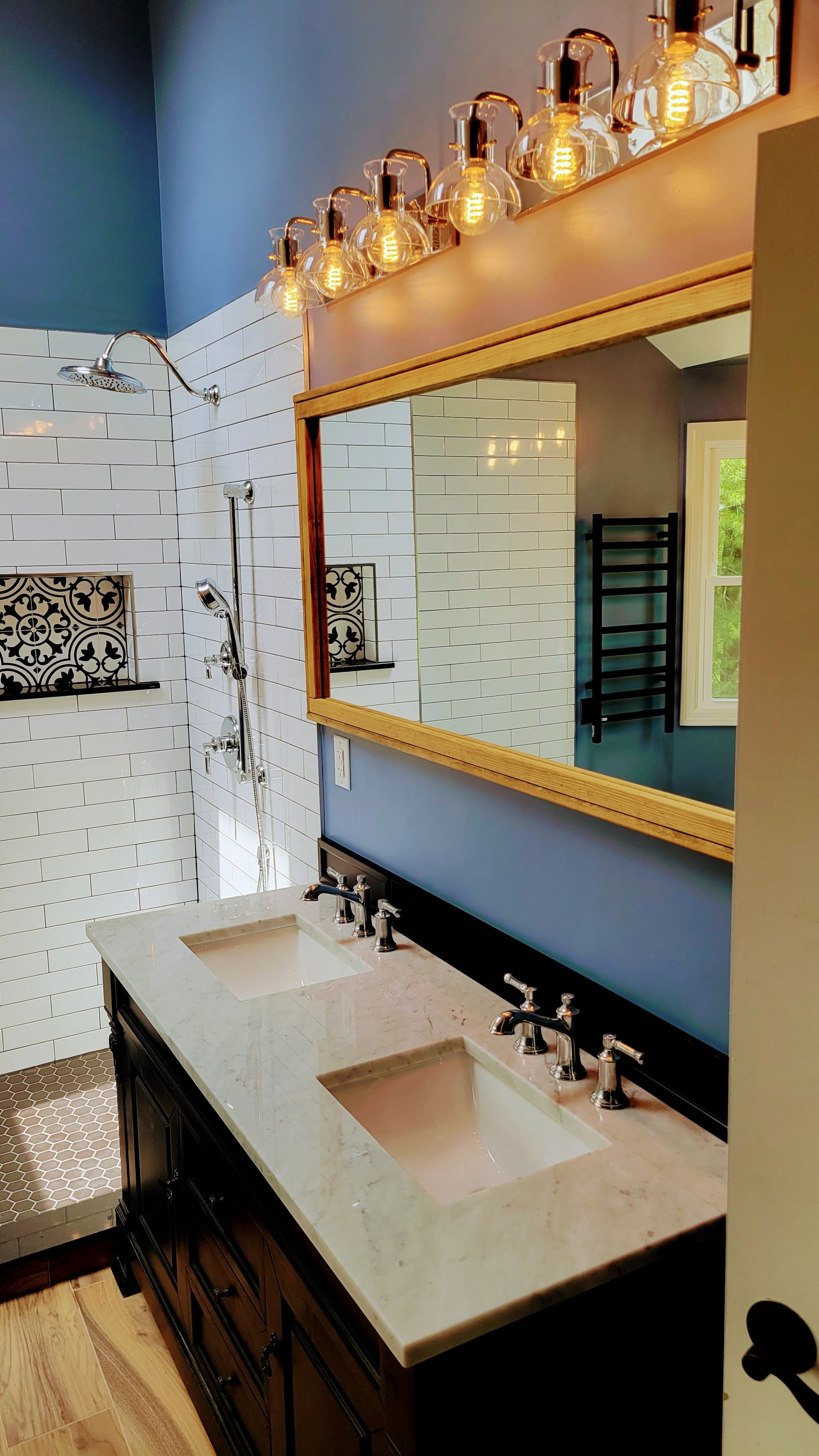 A bathroom with two sinks and a large mirror.