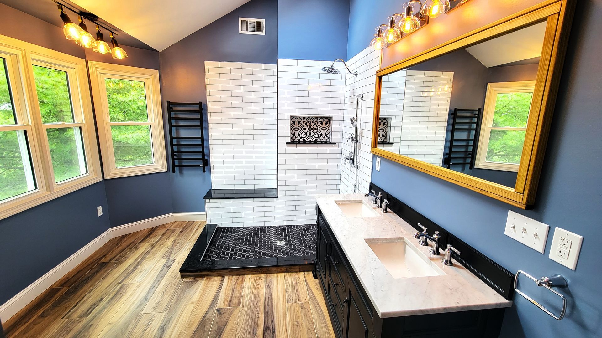 A bathroom with two sinks and a large mirror.