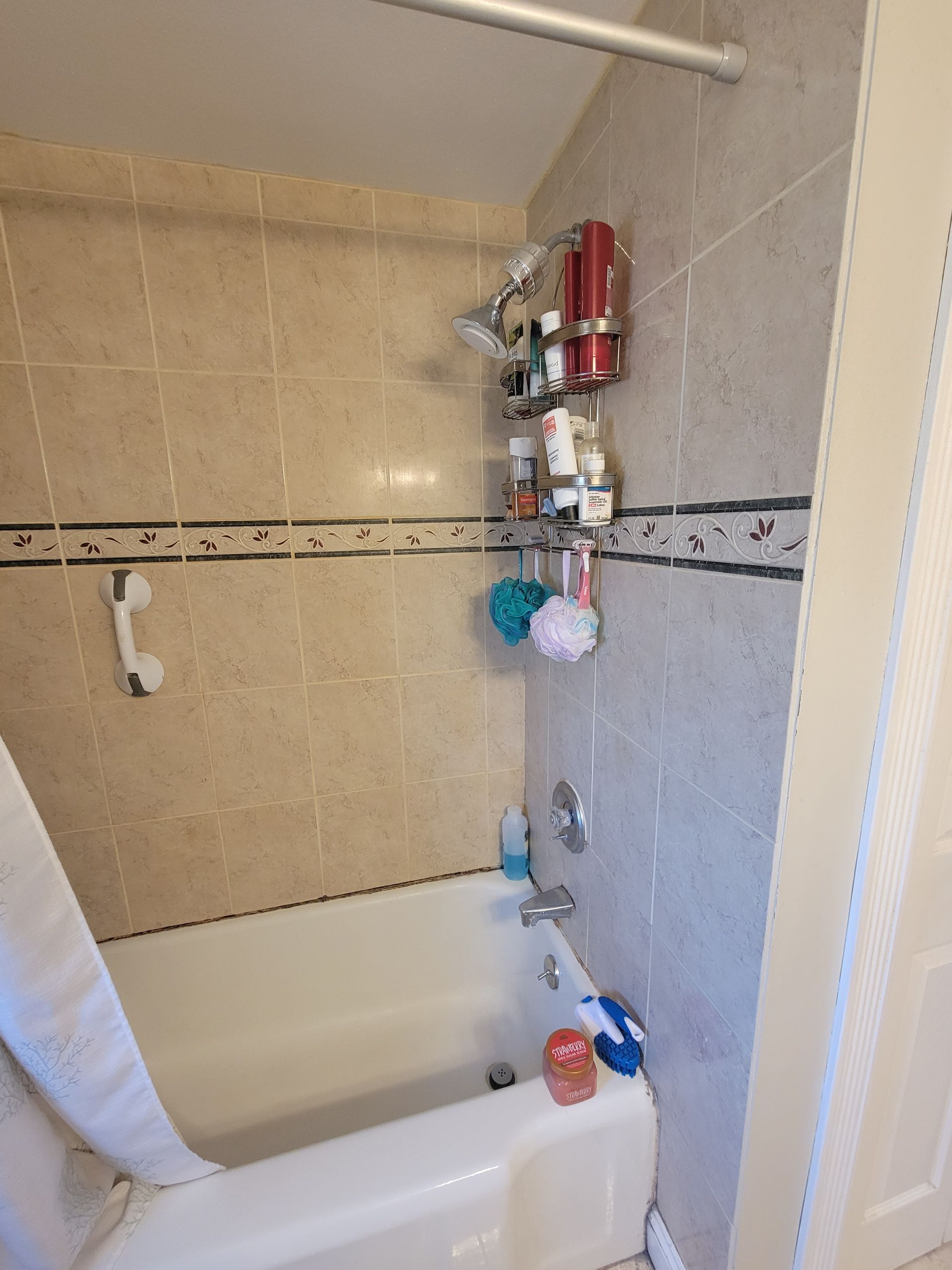 A bathroom with a bathtub and a shower.