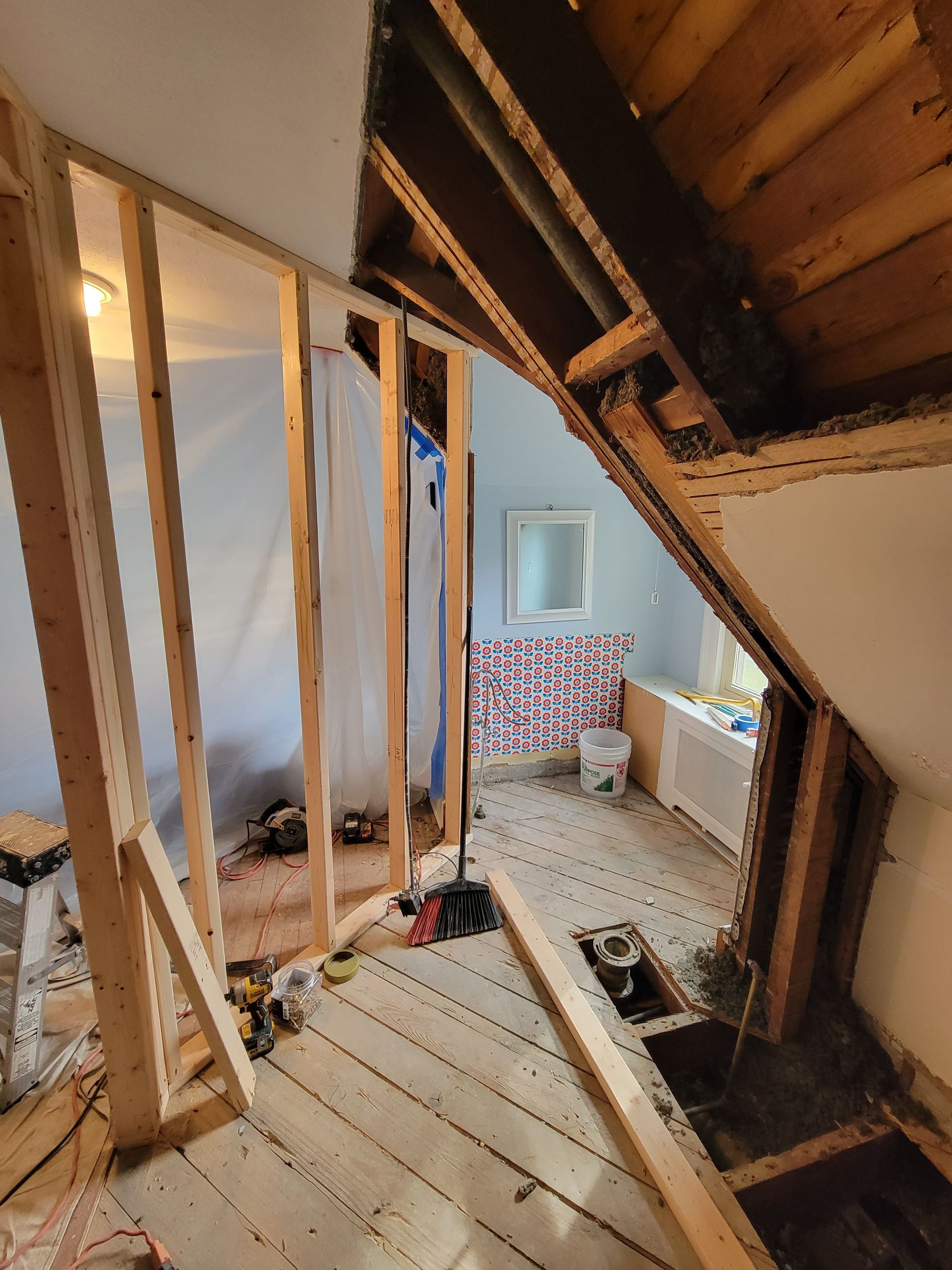 A room that is being remodeled with wooden walls and a bathtub.