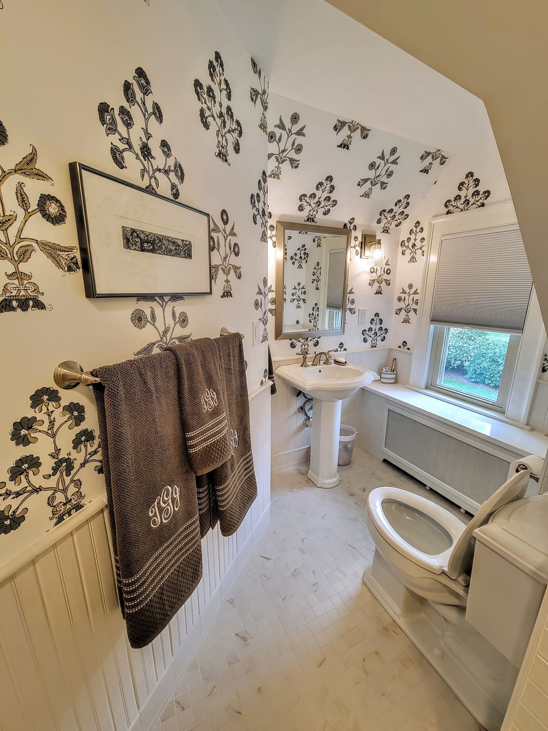 A bathroom with a toilet a sink and a mirror