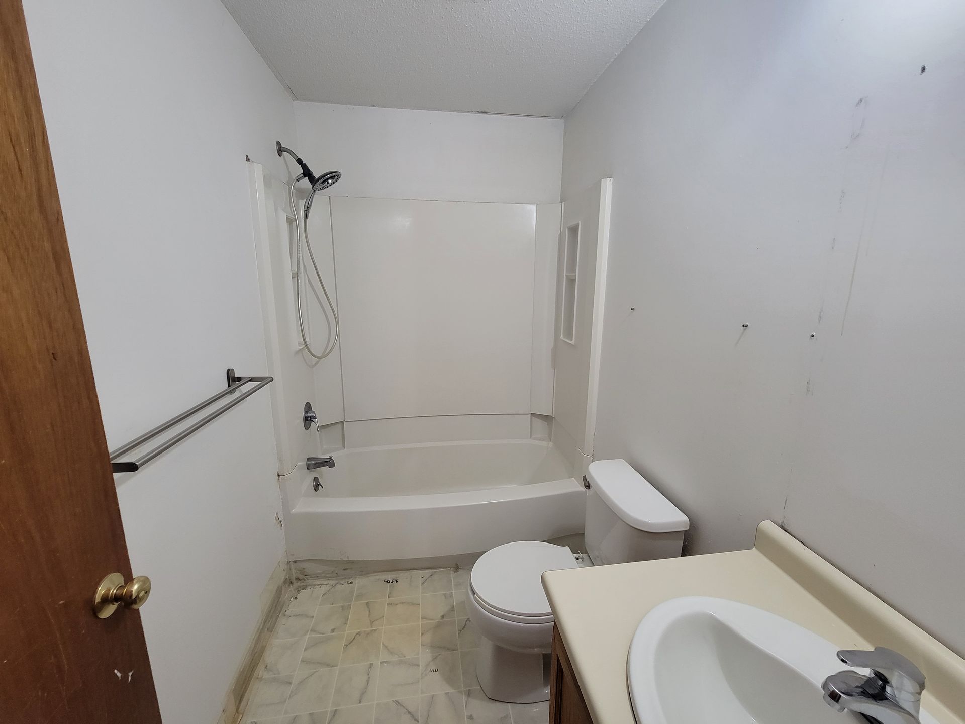 A bathroom with a toilet , sink and bathtub