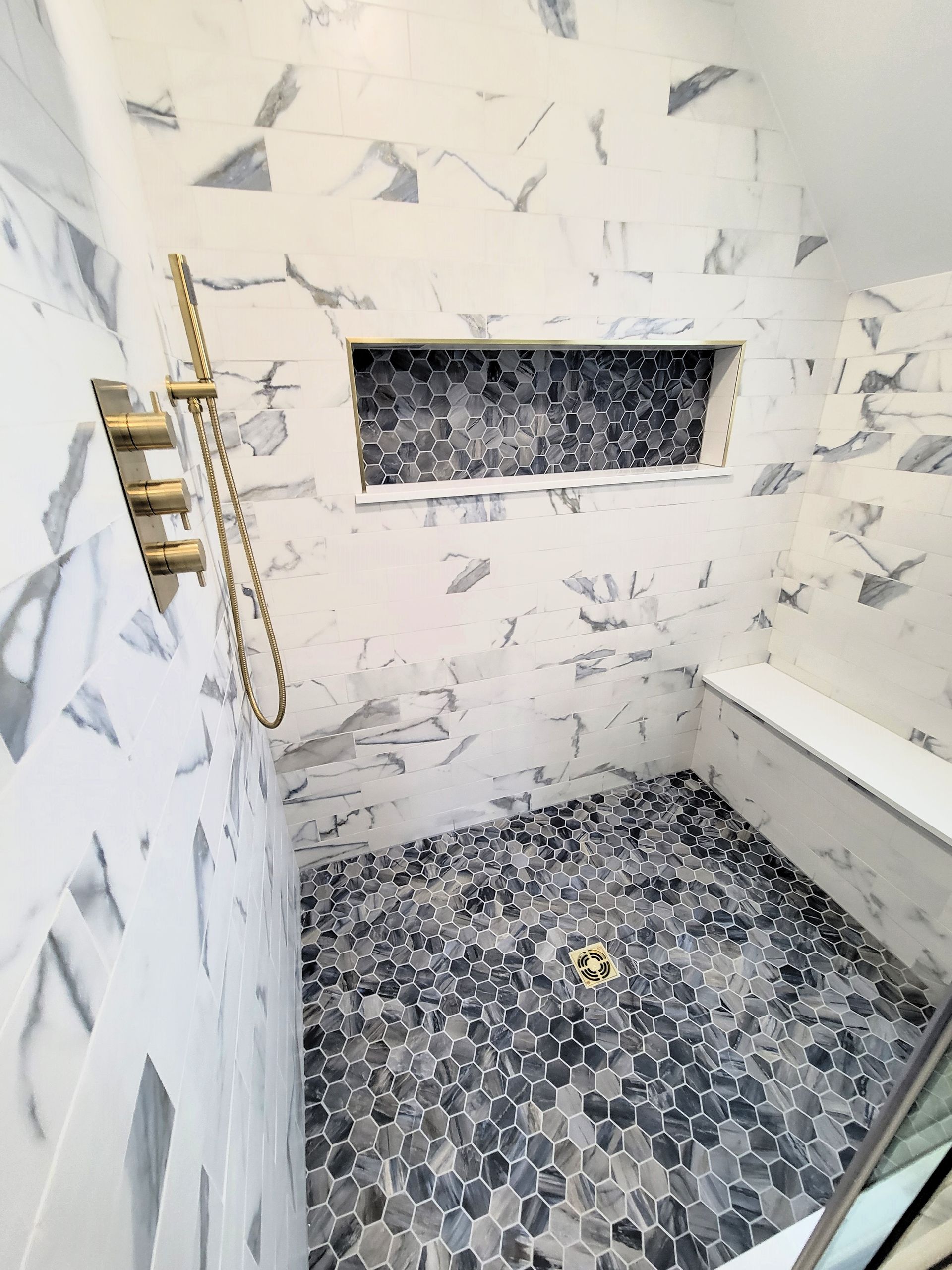 A bathroom with a walk in shower and a bathtub.