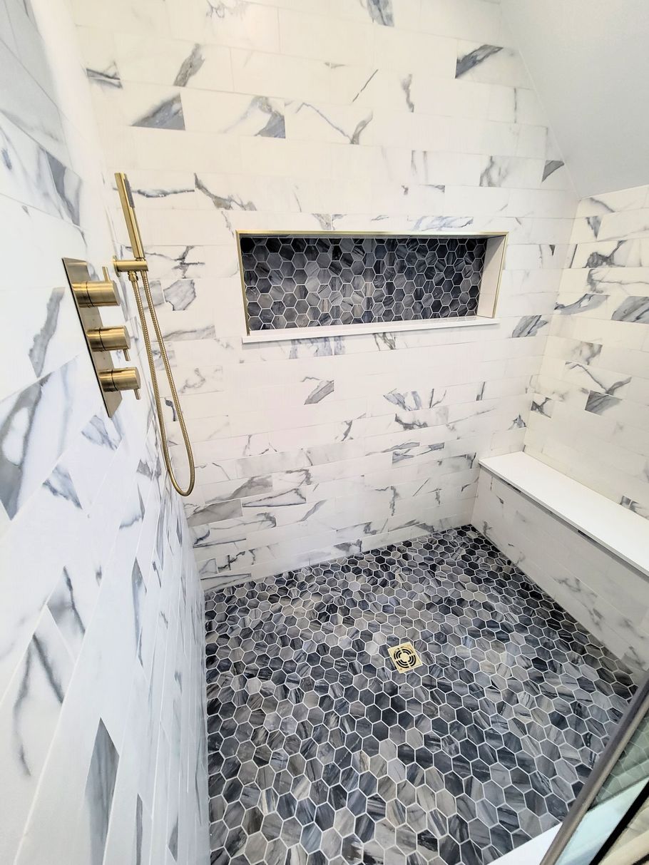 A bathroom with a walk in shower and a bathtub.