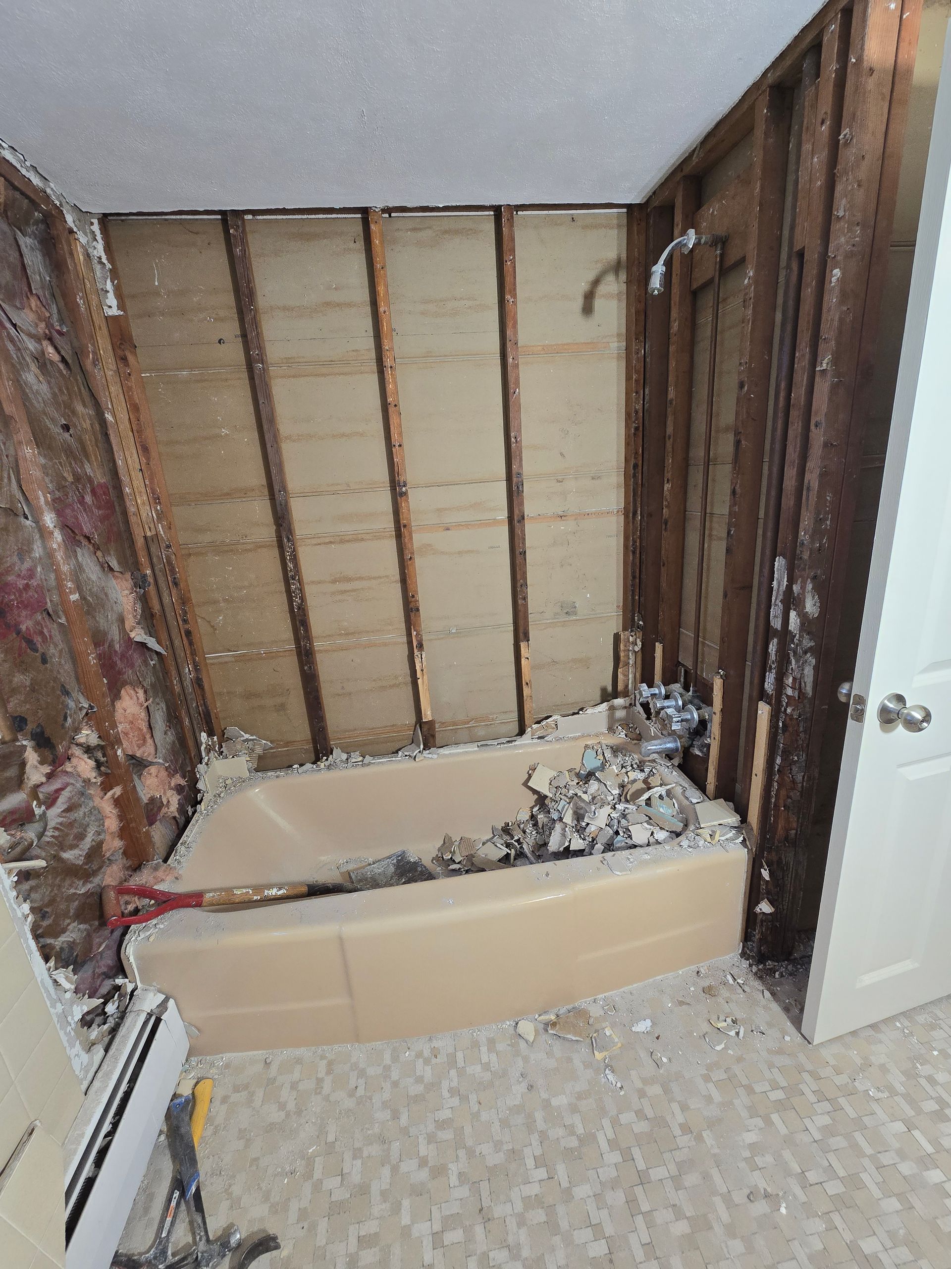 A bathroom with a bathtub and a shower being remodeled