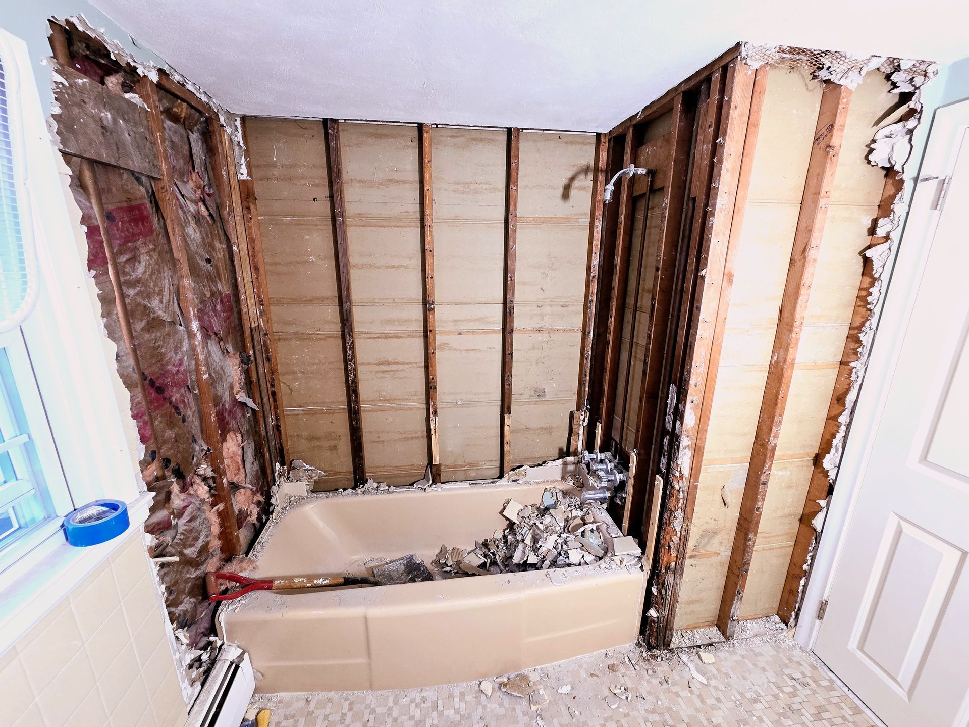 A bathroom is being remodeled with a bathtub and shower.