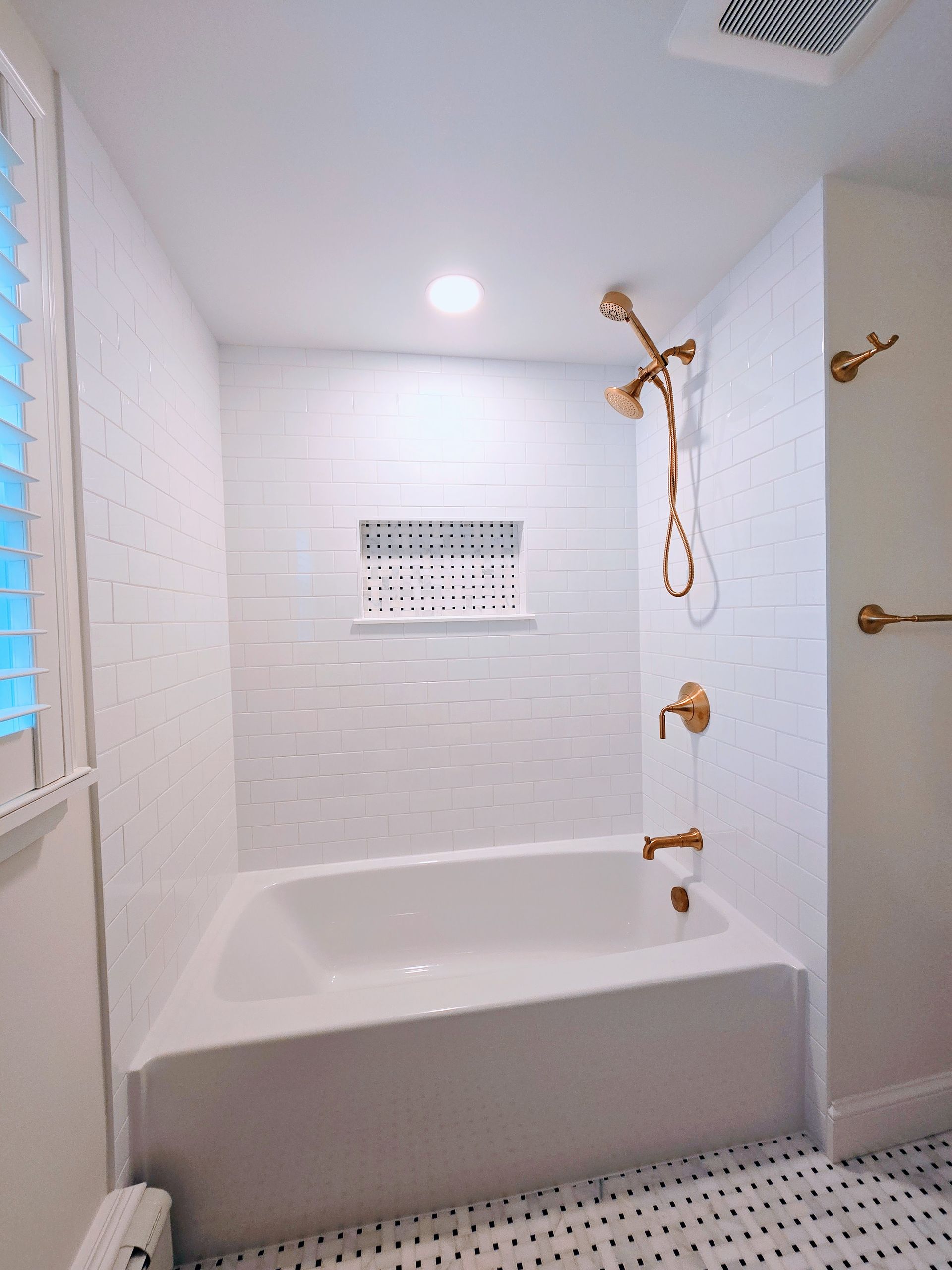 A bathroom with a bathtub and a shower.