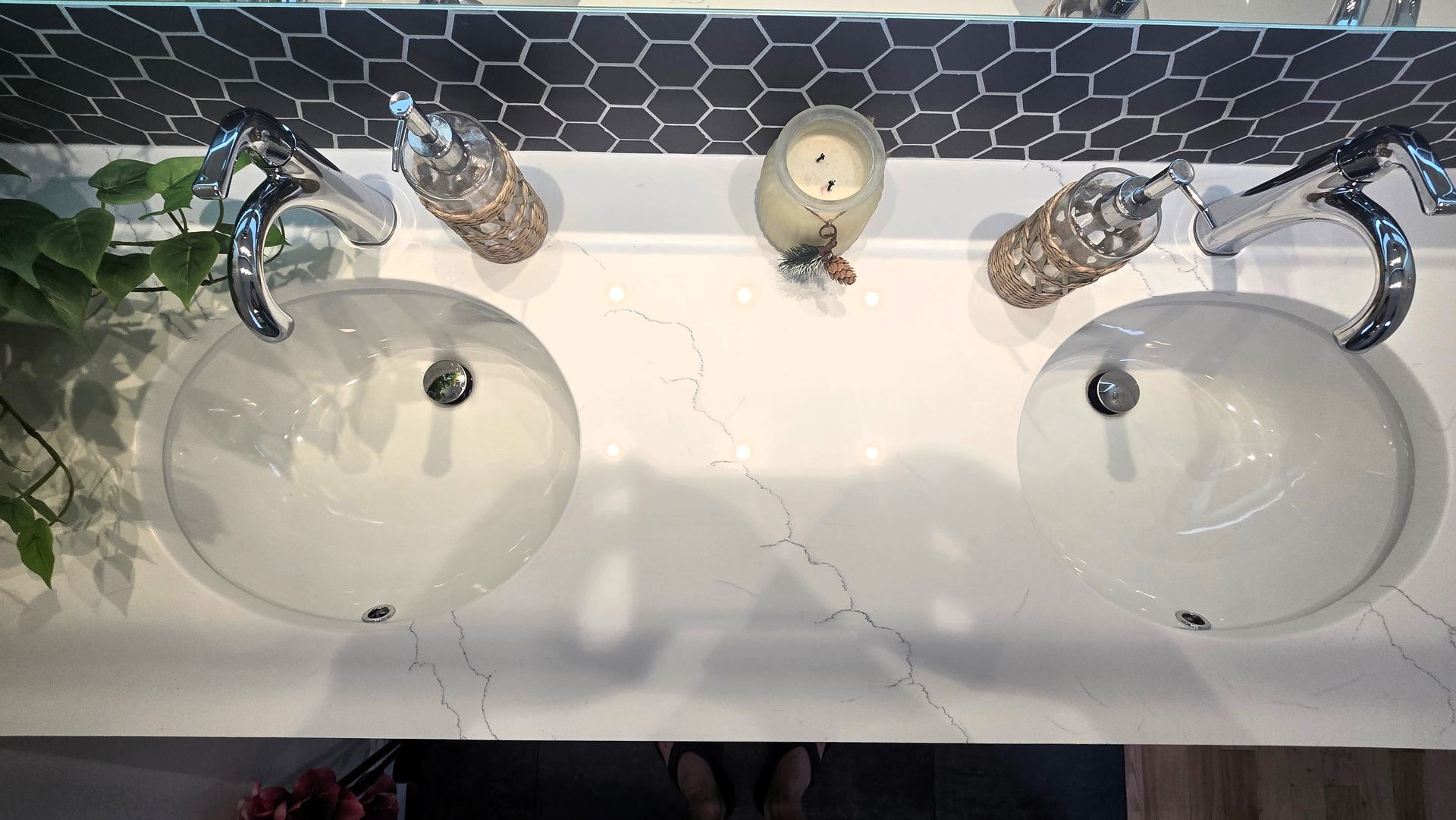 A bathroom with two sinks and a mirror.