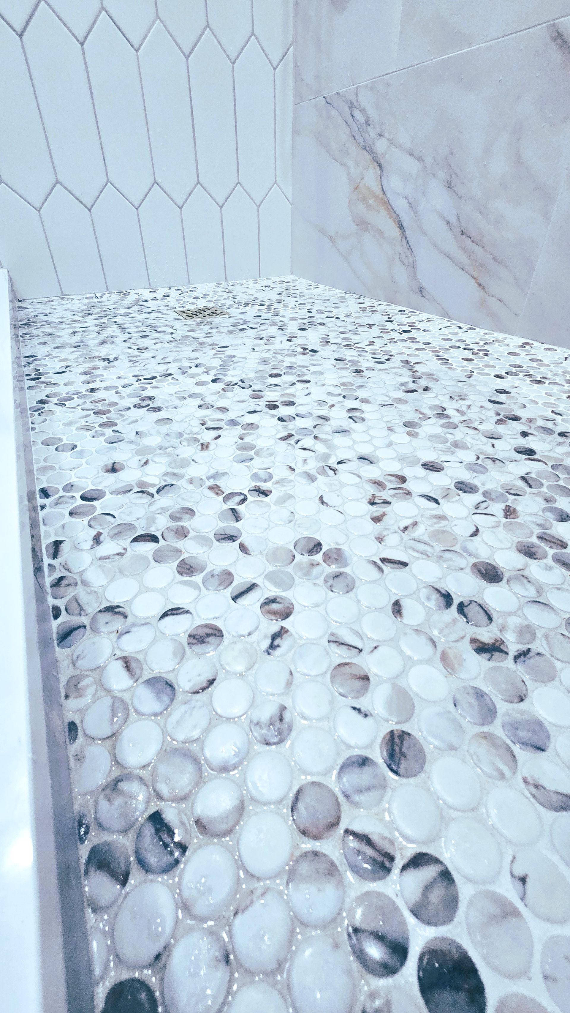 A close up of a tiled floor in a bathroom.