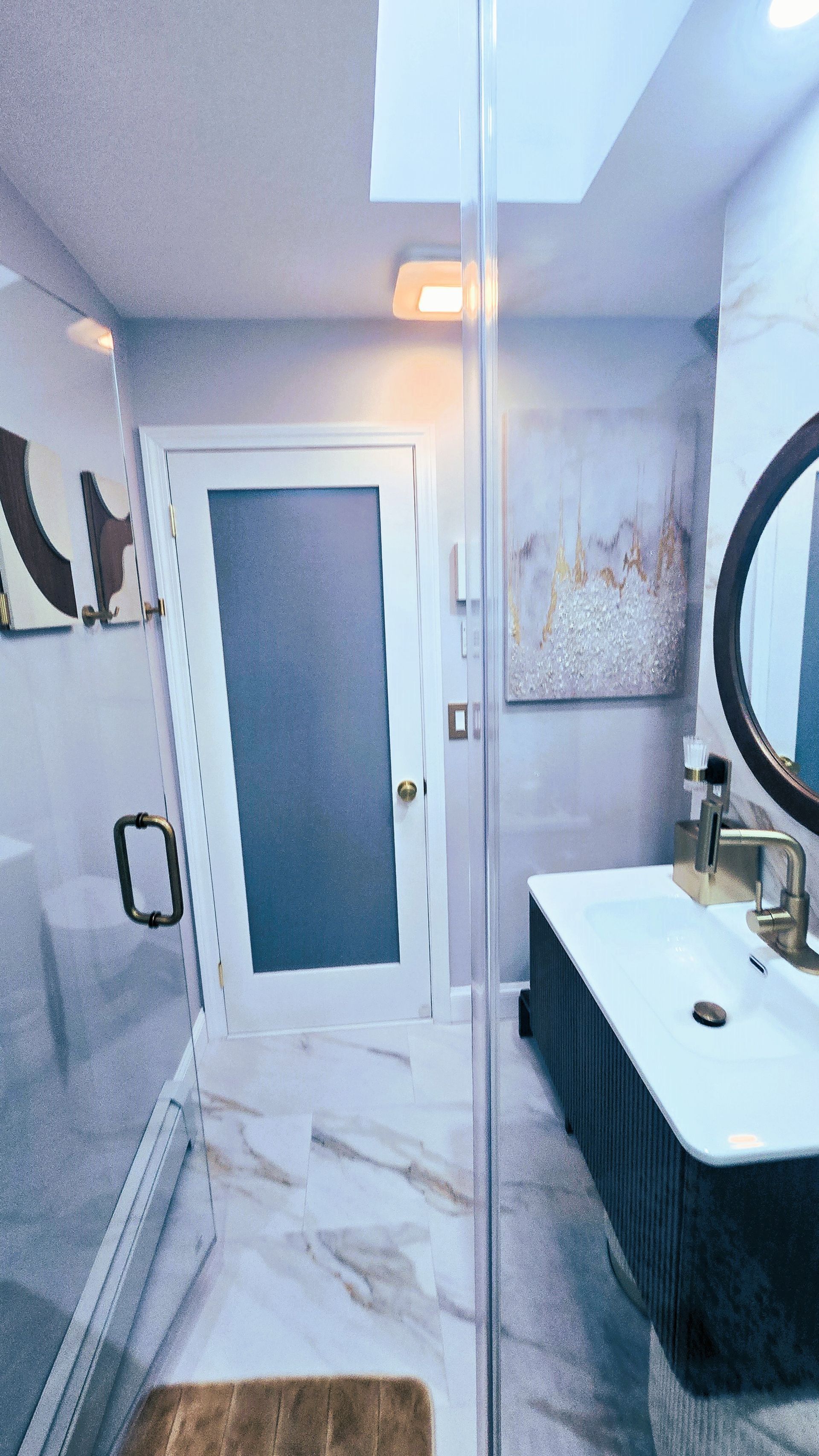 A bathroom with a sink , mirror and shower.
