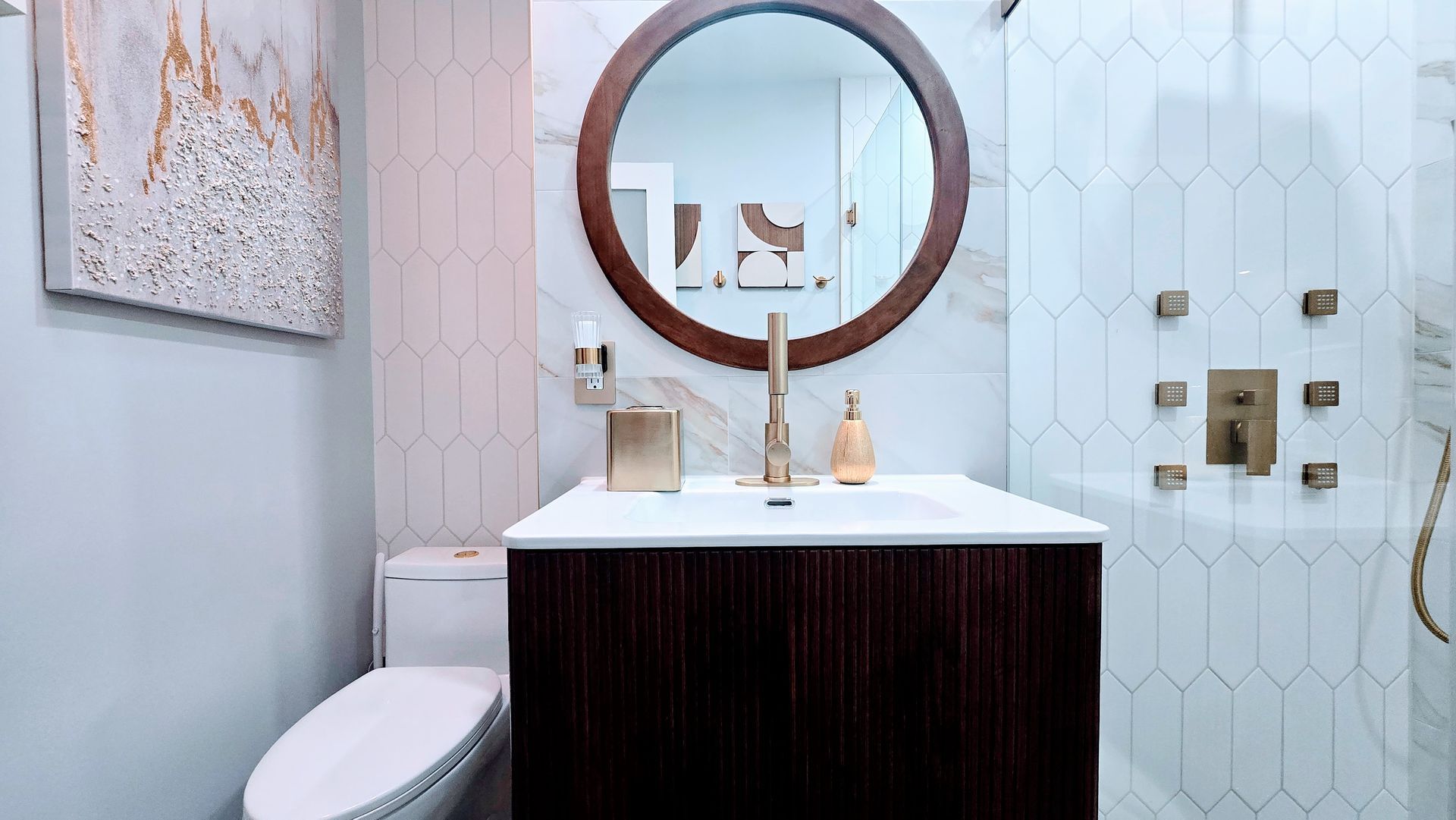 A bathroom with a toilet , sink , mirror and shower.