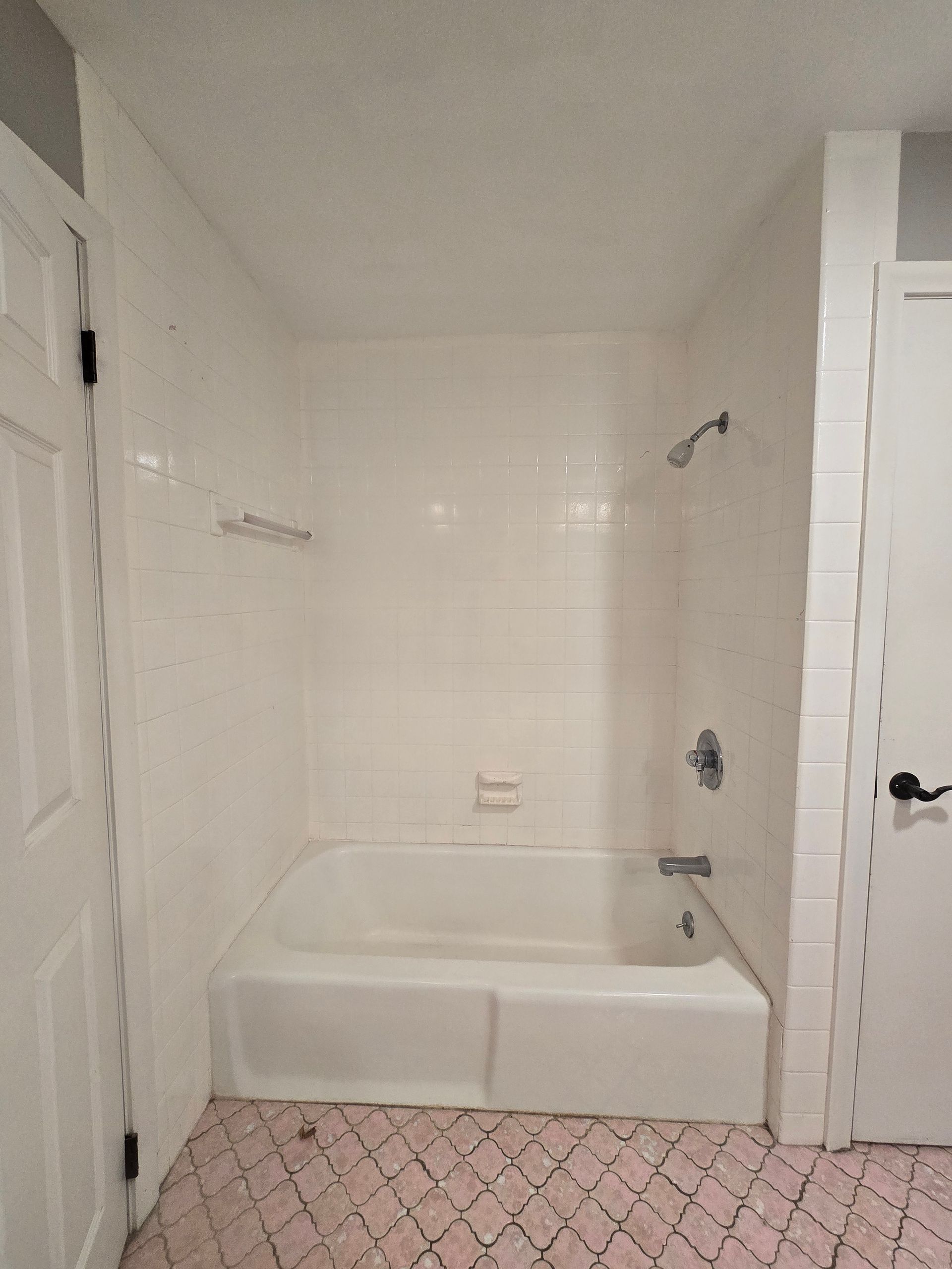 A bathroom with a bathtub and a shower.