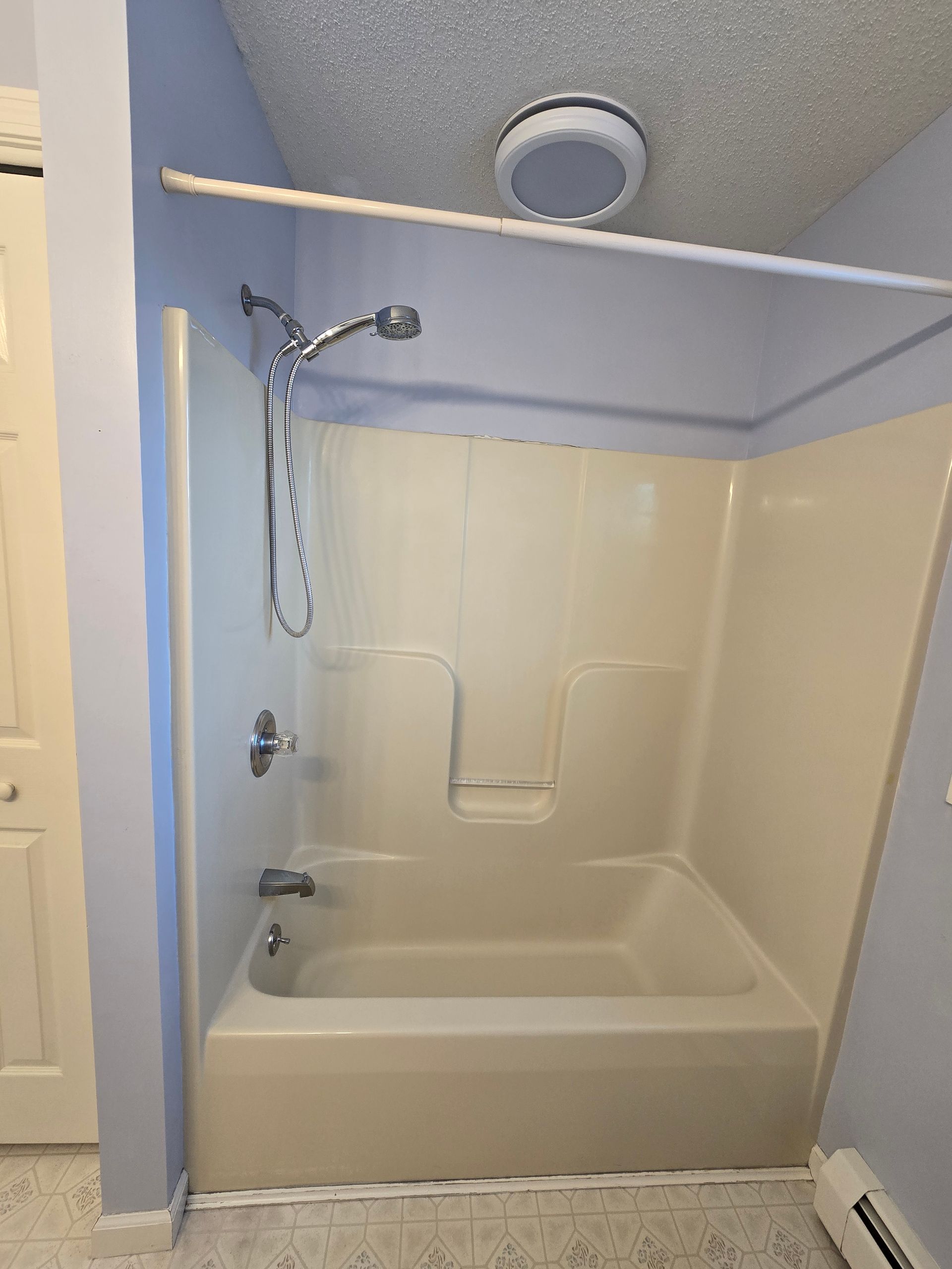A bathroom vanity is being remodeled with a hole in the wall.