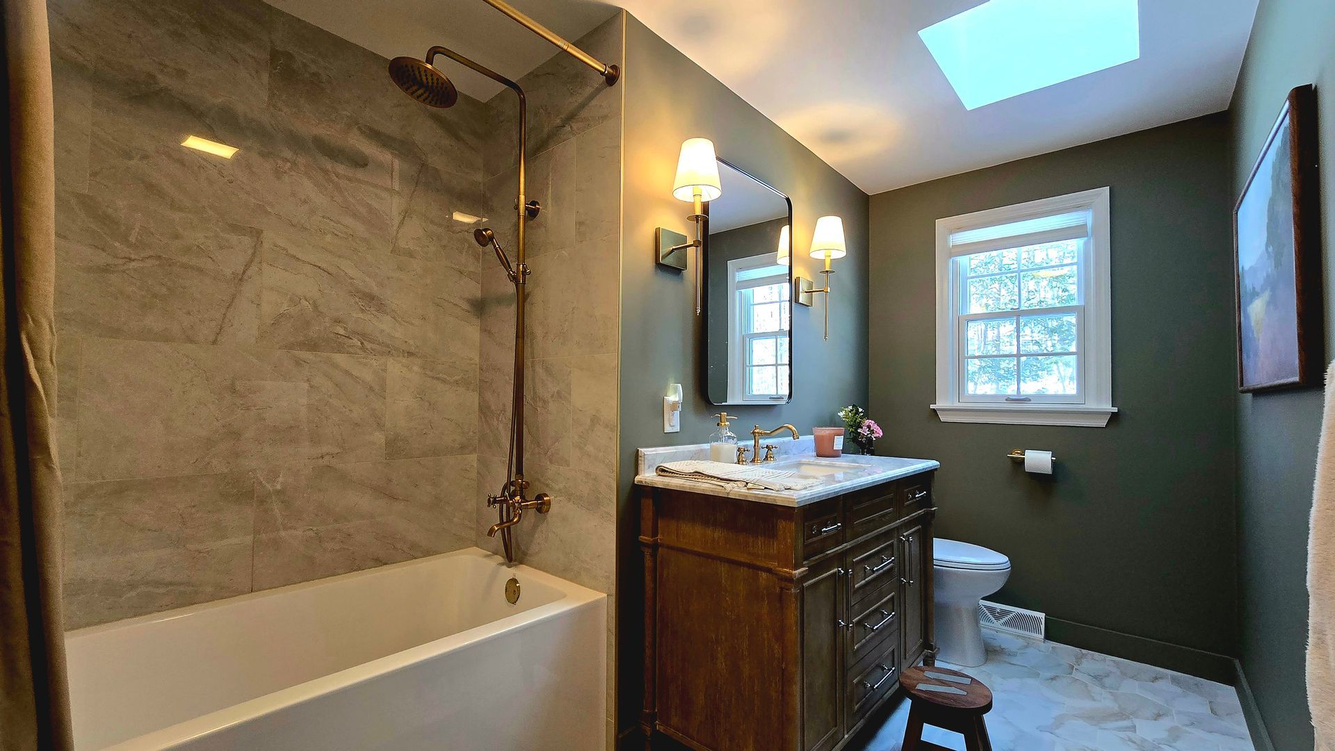 A bathroom with a tub , sink , toilet and shower.
