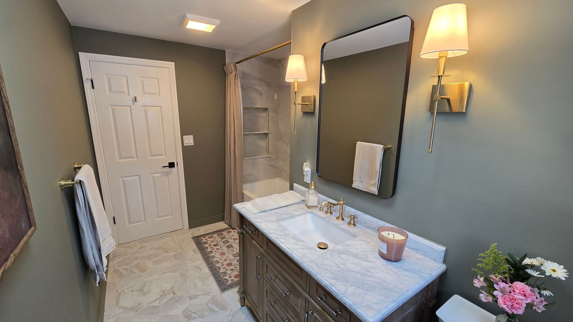 A bathroom with a sink , mirror , and toilet.