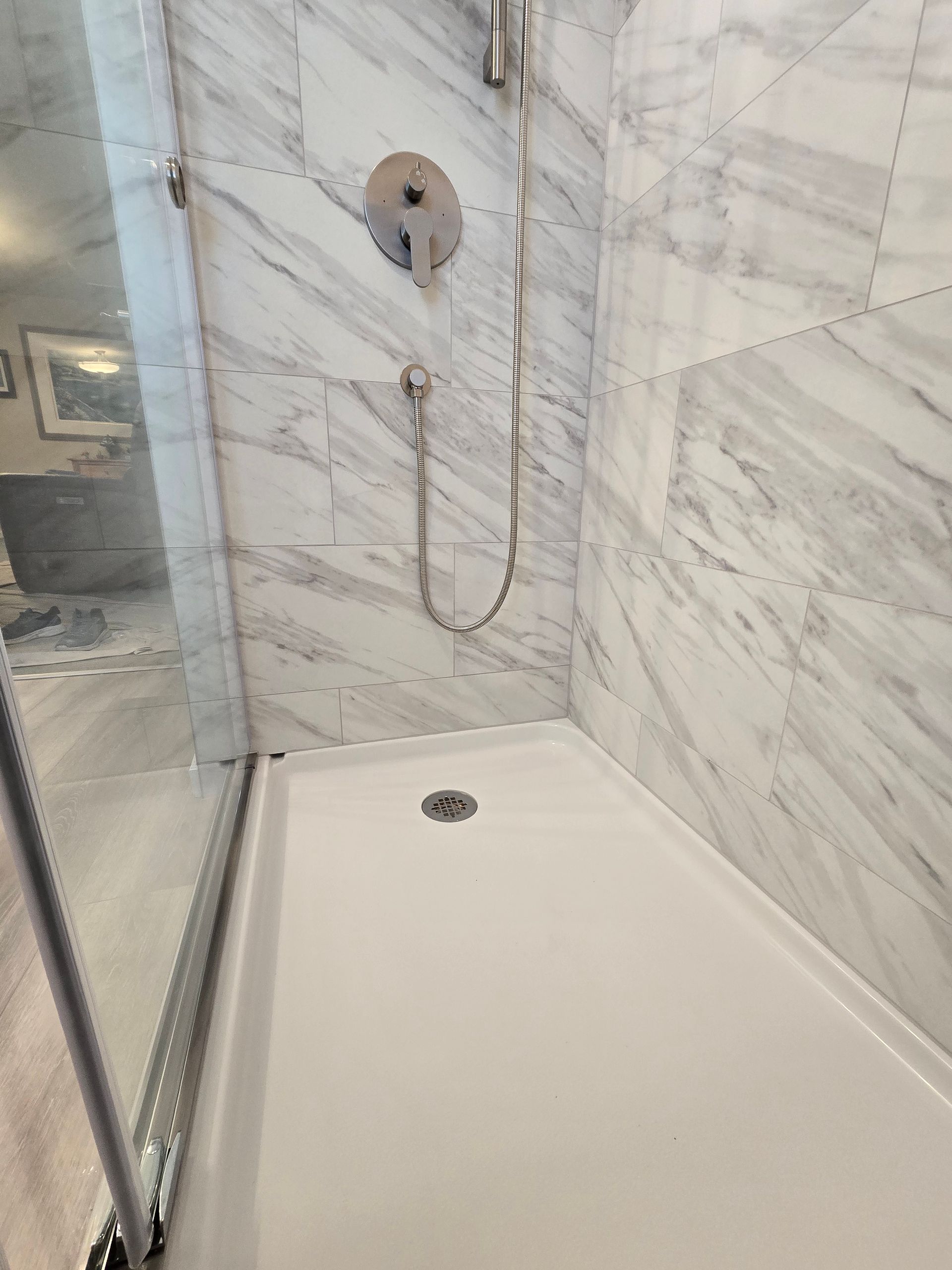 A bathroom with a sink , mirror , and toilet.