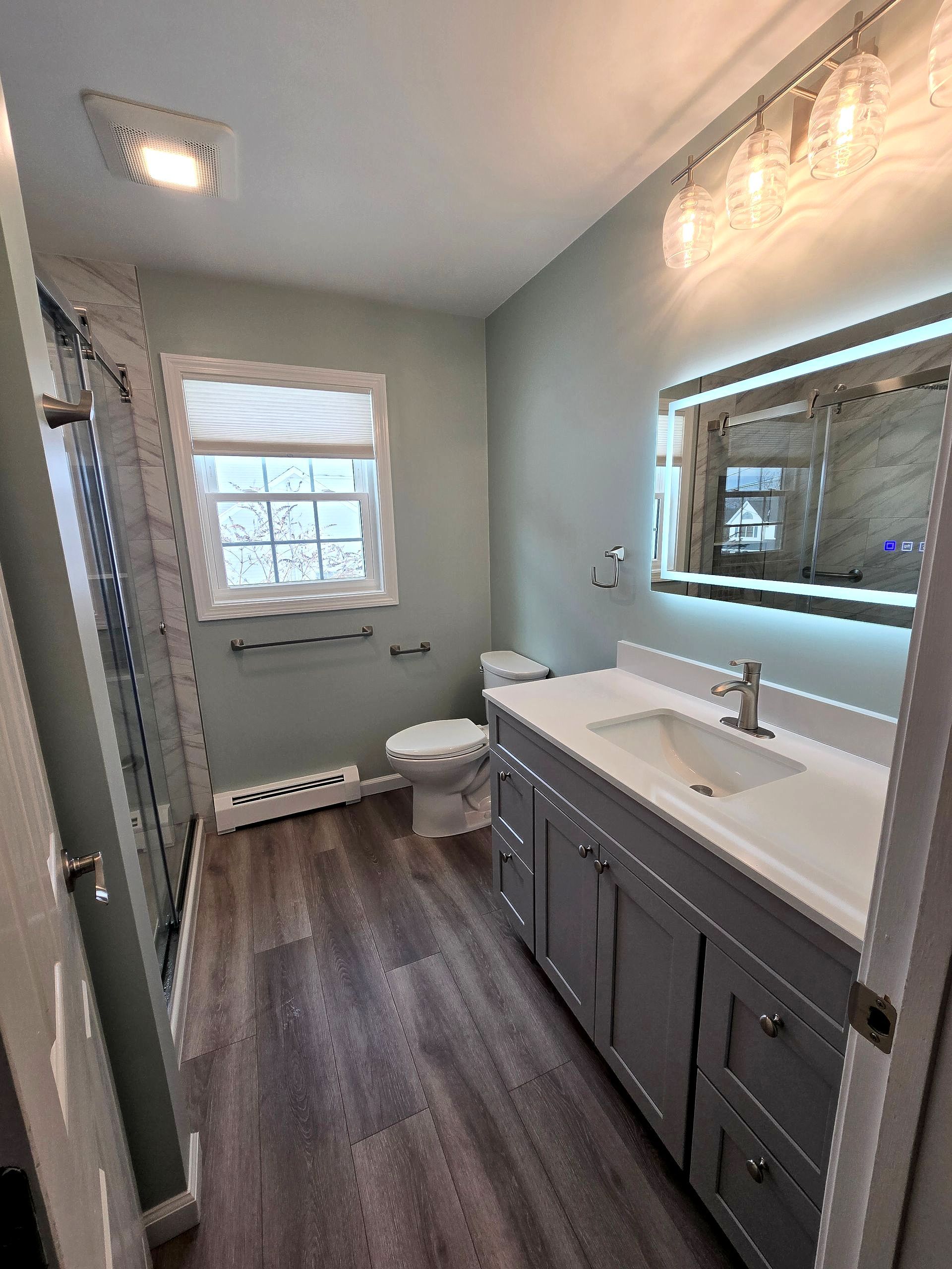 A bathroom with a bathtub and a shower head