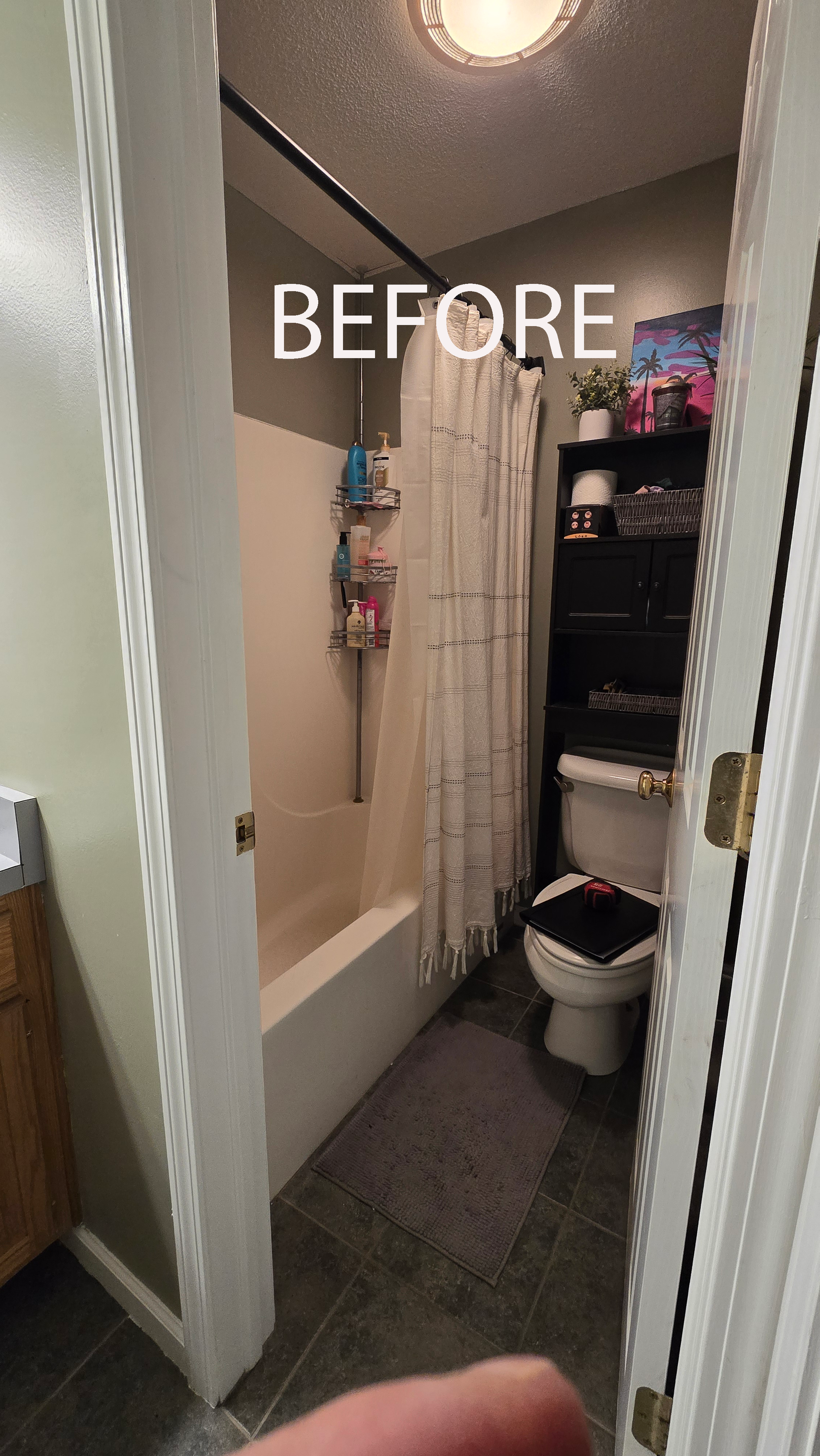West Simsbury Bathroom with wood vanity, large mirror, gray tile floor, and toilet near a window.